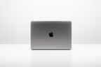 Image of macbook pro m1 sitting on plain white desk, there should be nothing in the image apart from the laptop, the background should also be plain white